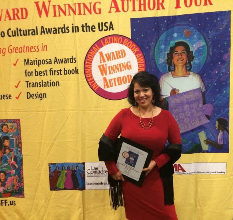 Photo of Quetzalmama receiving the 'Best Educational Young Adult Book' at the 2016 International Latino Book Awards.