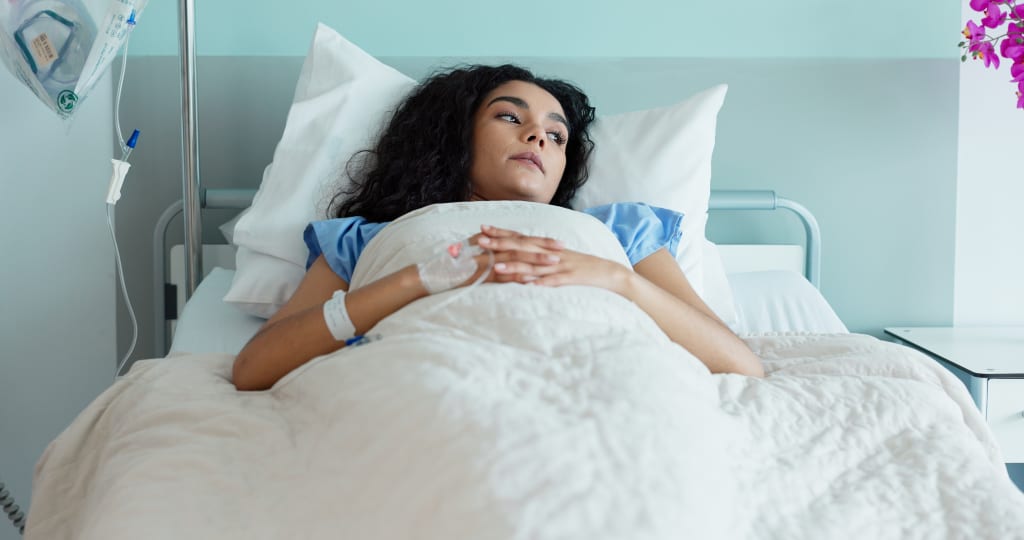 Woman in hospital bed receiving IV treatment abroad