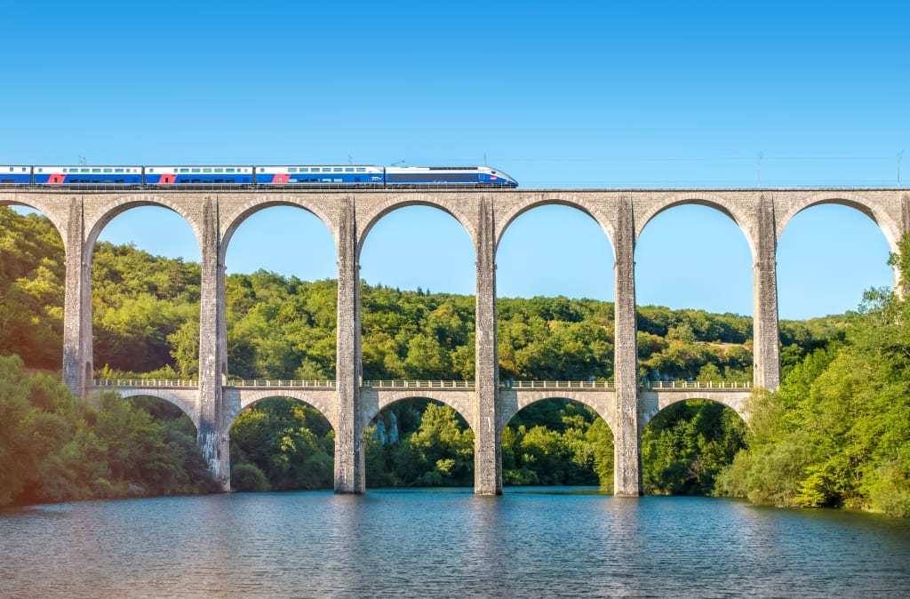 A high-speed train crossing Cize-Bolozon viaduct bridge in Ain, Rhone-Alpes region in France.