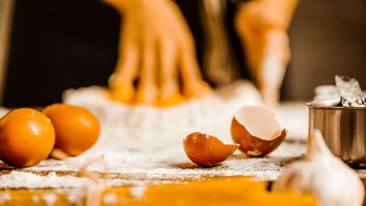 Pro using proper food handling and sanitary practice while baking with eggs.