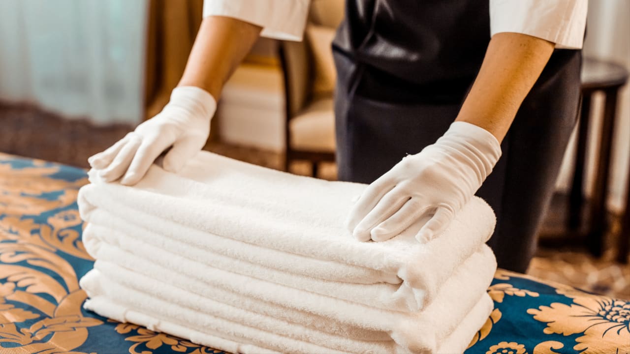Housekeeping Pro folding towels at a hotel.