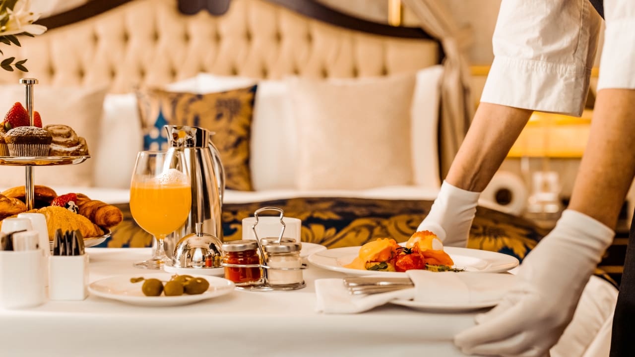 Banquet server delivering room service breakfast at a hotel. 