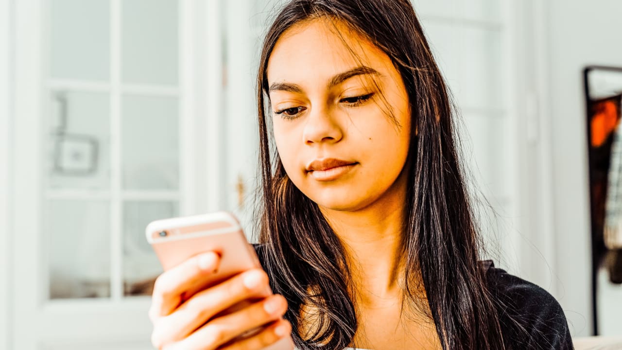 Female Pro looking at Gigpro app on her iPhone or Android.