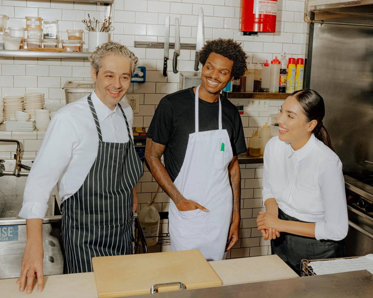 A hospitality professional at work in a busy kitchen
