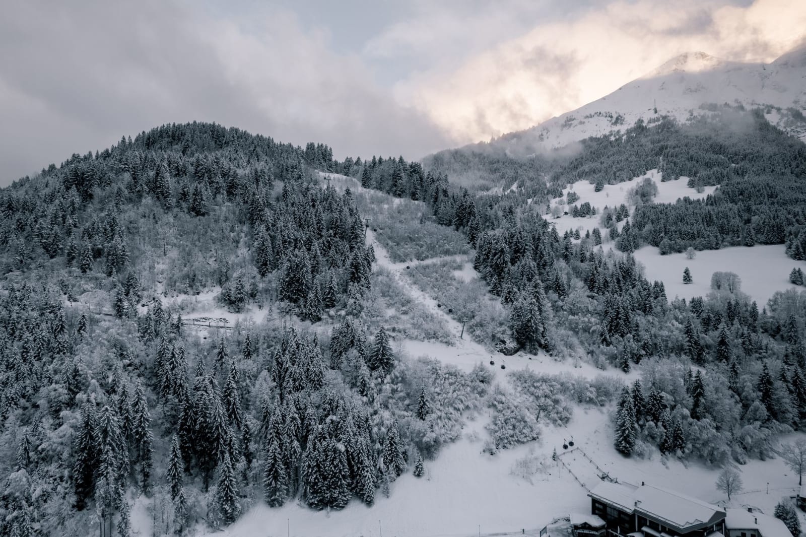 Beautiful winter scene of the snow-covered slopes and forests in Les Contamines-Montjoie, France.