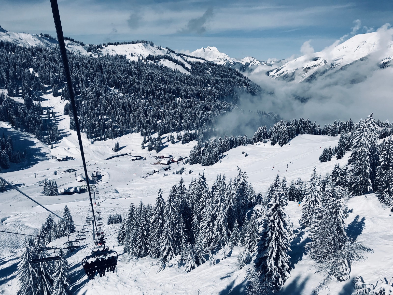 A cable car above snowy pines and ski slopes in Morzine