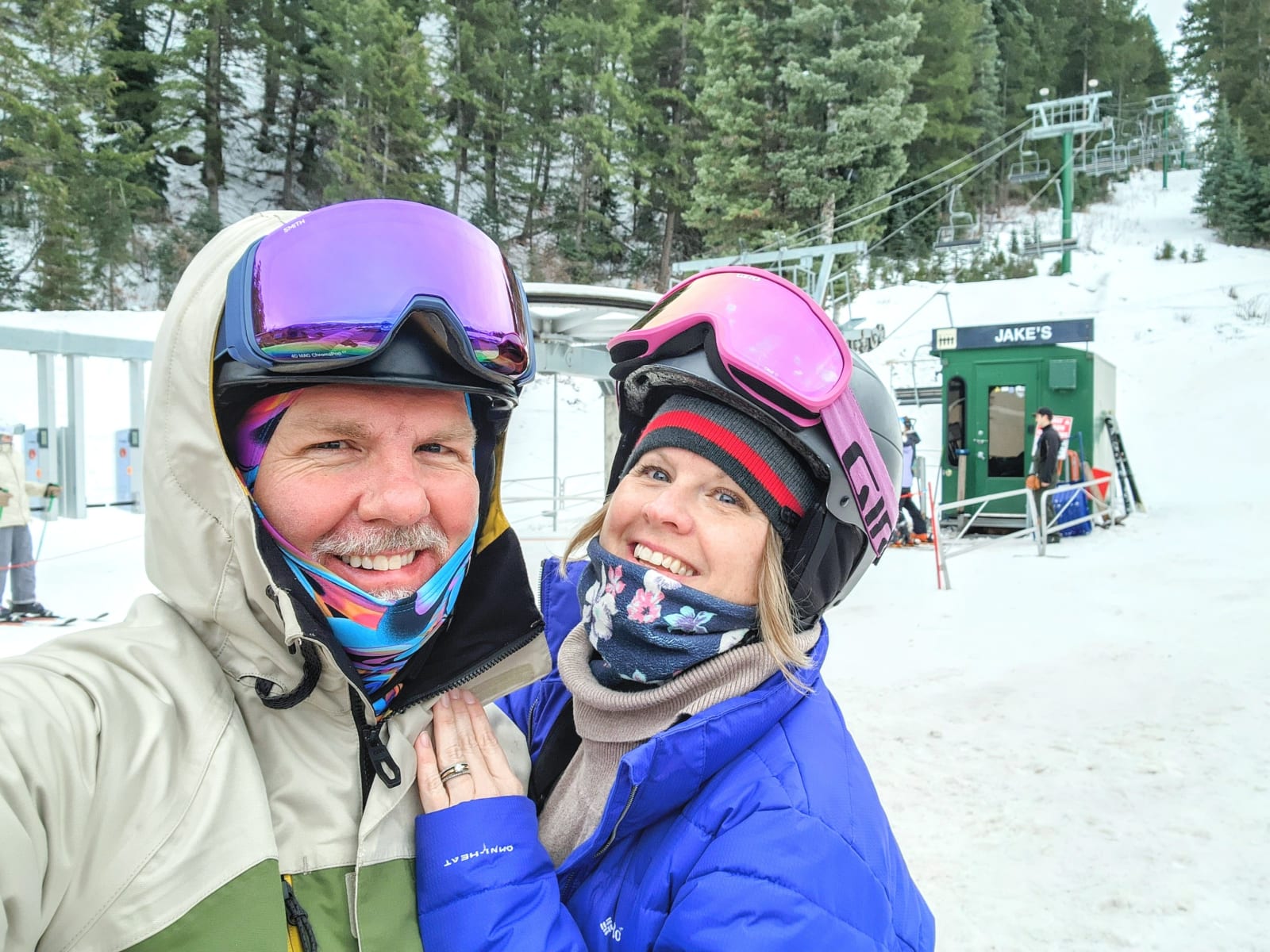 A smiling couple in ski gear at the Sundance Resort lift, Utah