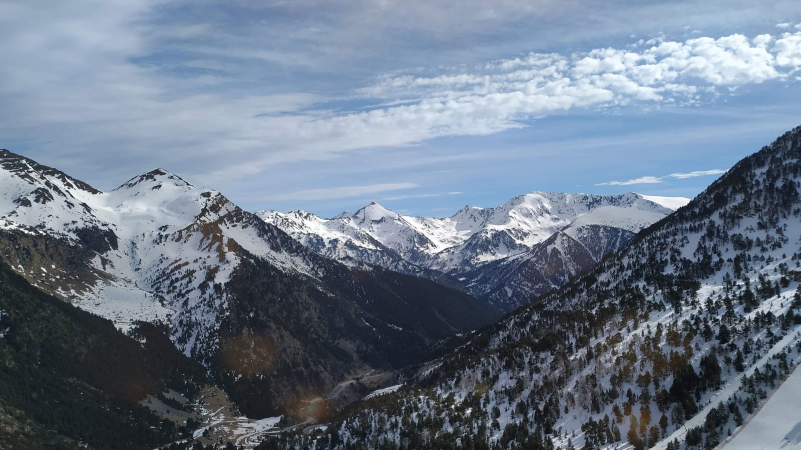 Snow-capped mountains above Ordino, Andorra, under a blue sky