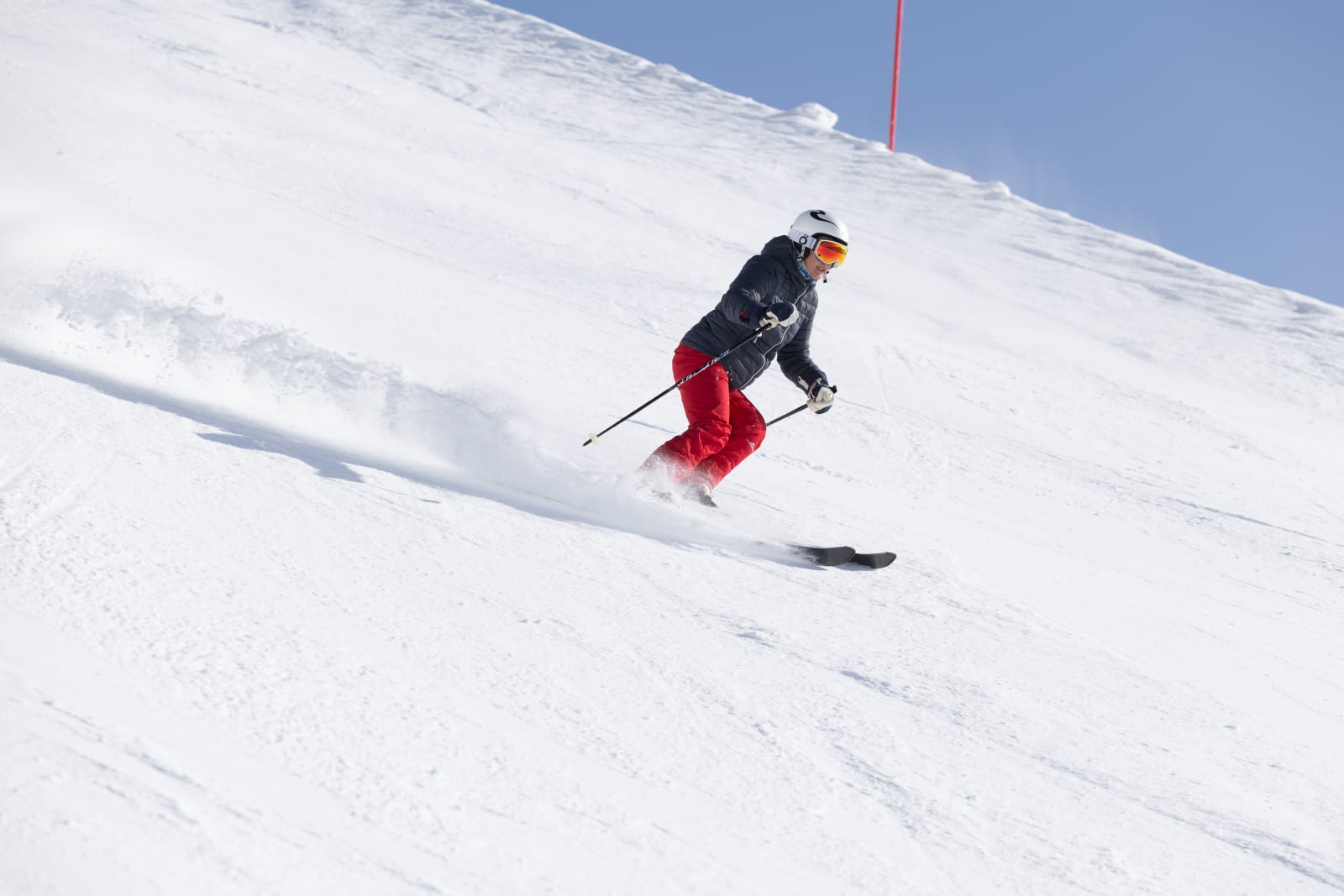 A skier carving a sunny slope at Ischgl