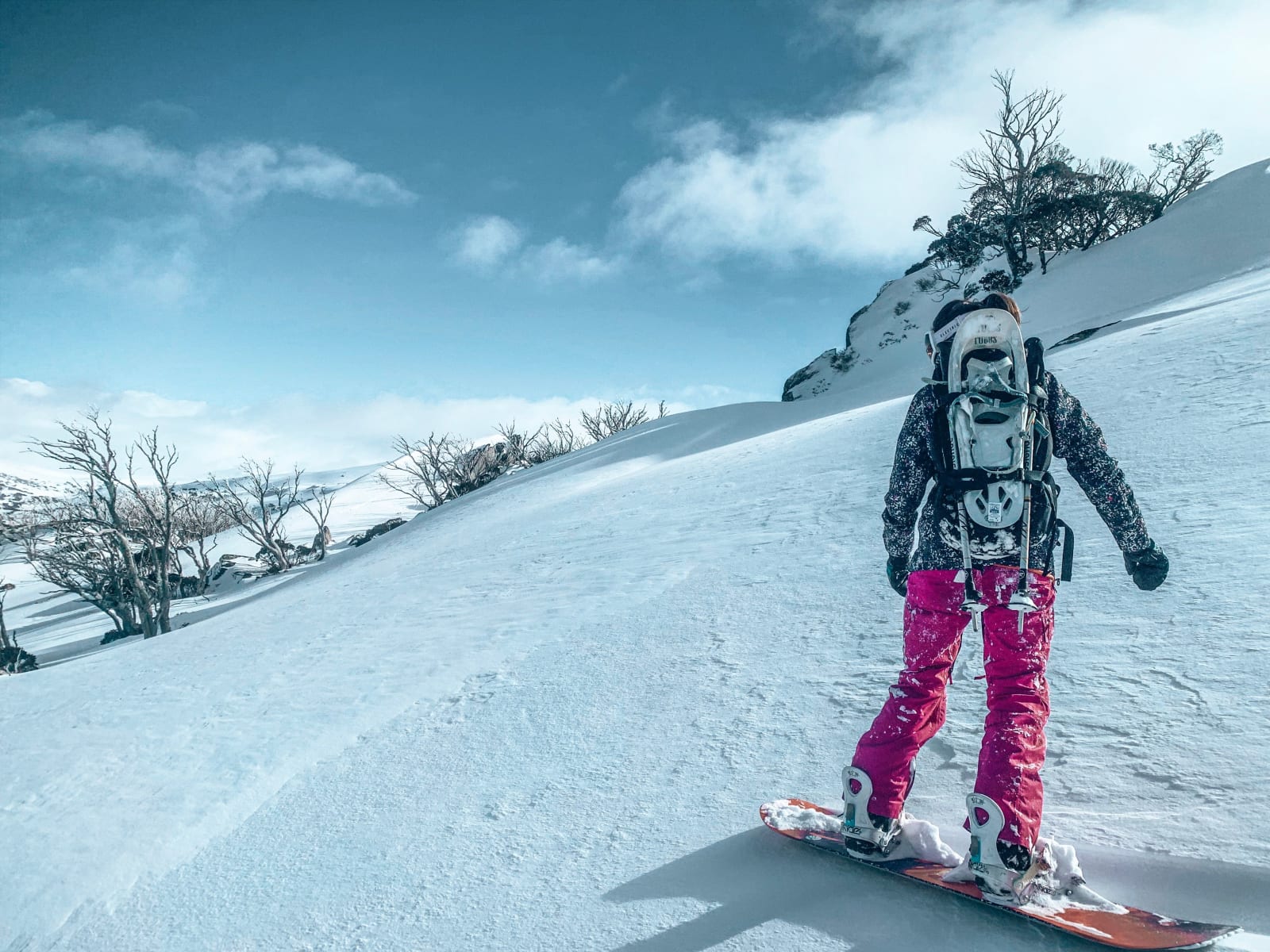 A snowboarder on a snowy slope in Kosciuszko National Park