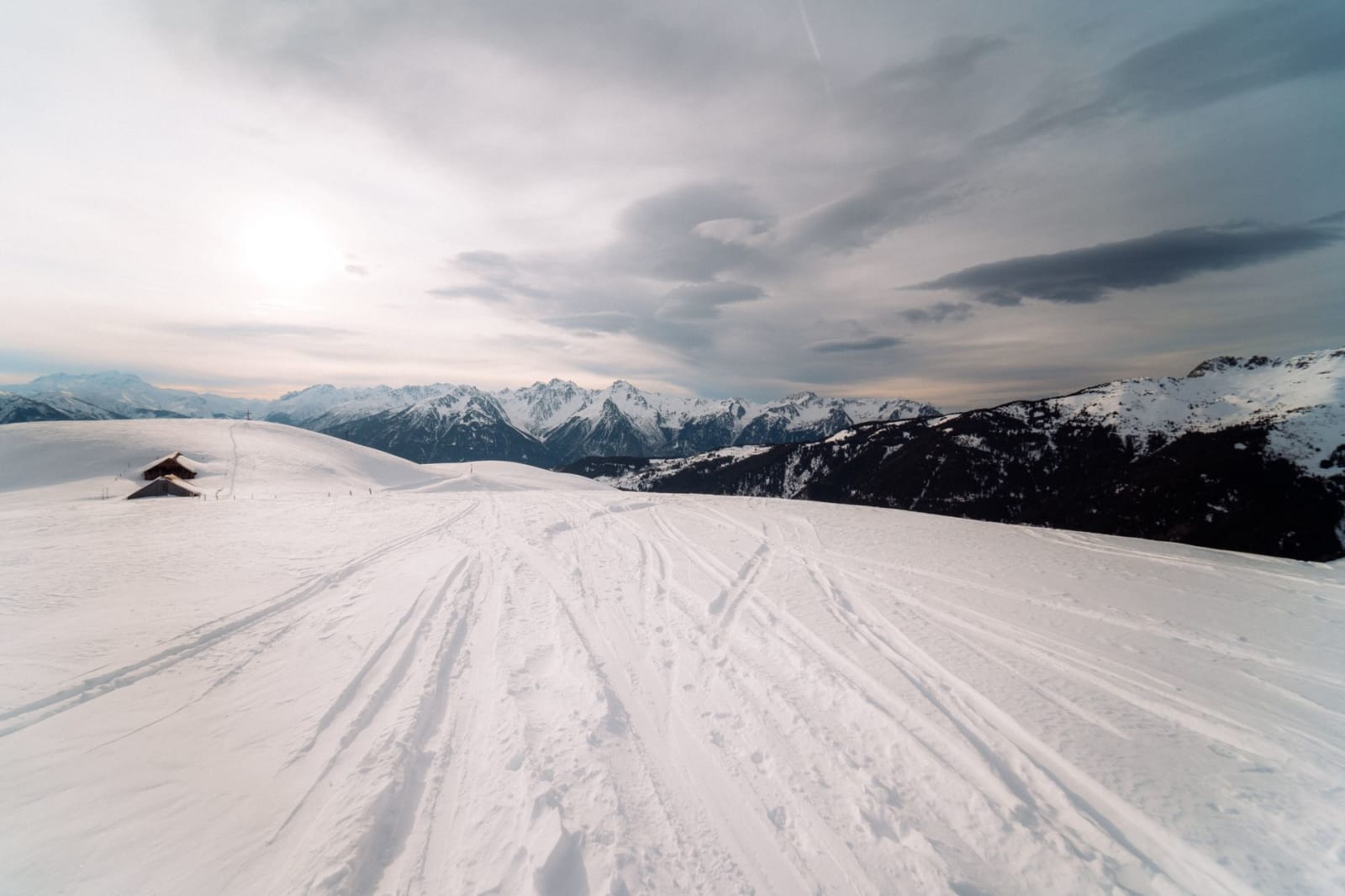 Scenic winter view of snow-covered ski slopes at Saint-François-Longchamp, with majestic mountains.