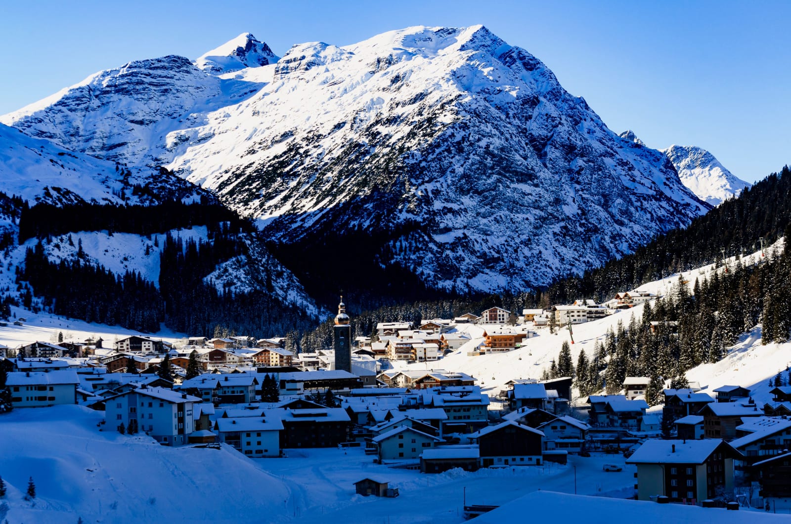 Lech village under snow with the Alps behind