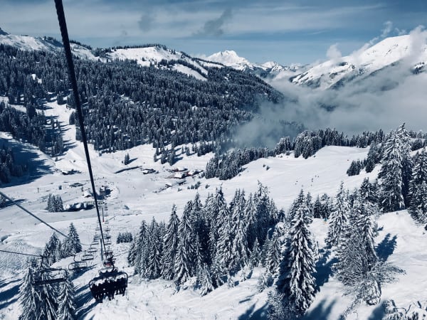 A cable car above snowy pines and ski slopes in Morzine