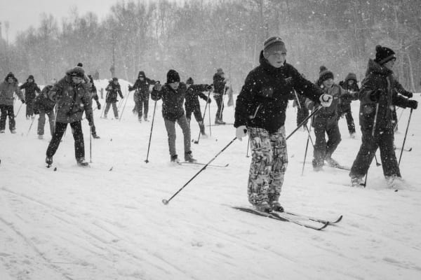 Illustrative photo: Anastasia Kostyleva / Pexels A group of youth skiing together in a snowstorm, capturing the excitement and challenge of winter sports.