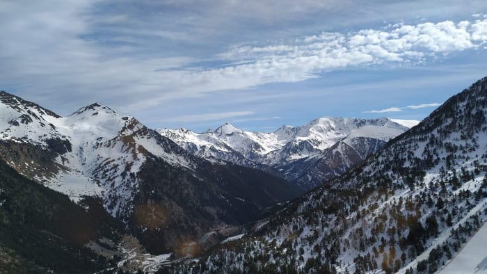 Snow-capped mountains above Ordino, Andorra, under a blue sky
