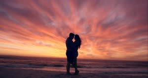 couple kissing sunset
