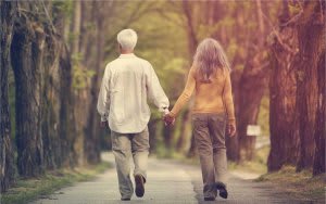 couple walking through trees