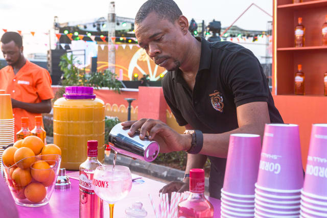 A bartender serving the new Gordon gin drinks