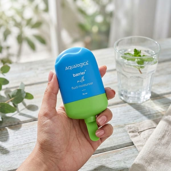 Aqualogica 5 Barrier+ Milk Fluid Moisturizer - 70 ml held in hand, candid photo