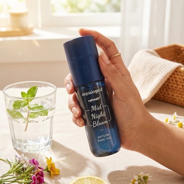 Aqualogica Refresh+ Mid Night Bloom Perfume Body Mist with Zemea & Hyaluronic Acid (150 ml) held in hand, candid photo