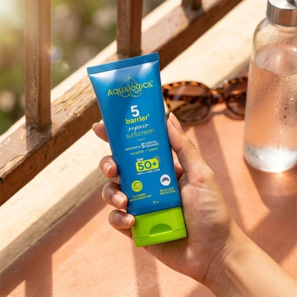 Aqualogica 5 Barrier+ Repair Sunscreen with Avocado & 5 Essential Ceramides 80 gm held in hand, candid photo