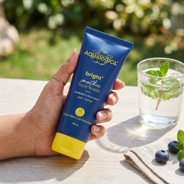 Aqualogica Bright+ Smoothie Face Wash 100ml held in hand, candid photo