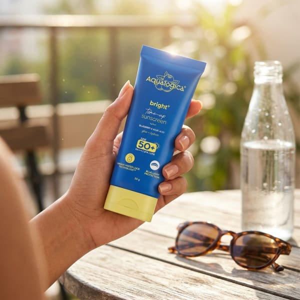 Aqualogica Bright+ Tone Up Sunscreen 50g held in hand, candid photo