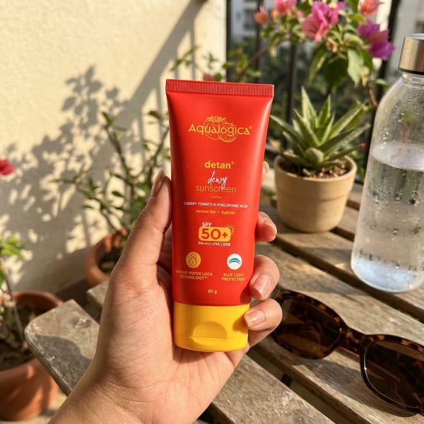 Aqualogica FREEBIE | Detan+ Dewy Sunscreen with SPF 50+ & PA++++ for UVA/B & Blue Light Protection  & No White Cast - 80g held in hand, candid photo