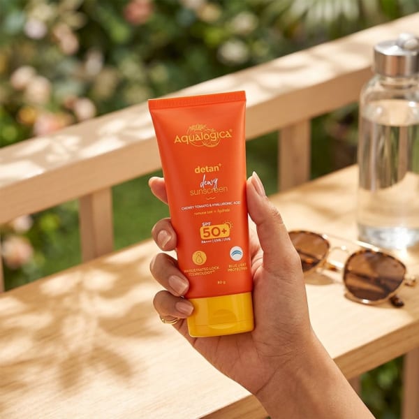 Aqualogica FREEBIE | Detan+ Dewy Sunscreen with SPF 50+ & PA++++ for UVA/B & Blue Light Protection  & No White Cast - 80g held in hand, candid photo