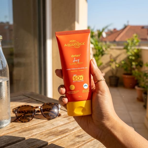 Aqualogica FREEBIE | Detan+ Dewy Sunscreen with SPF 50+ & PA++++ for UVA/B & Blue Light Protection  & No White Cast - 80g held in hand, candid photo