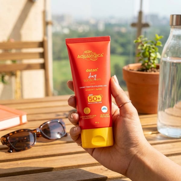 Aqualogica FREEBIE | Detan+ Dewy Sunscreen with SPF 50+ & PA++++ for UVA/B & Blue Light Protection  & No White Cast - 80g held in hand, candid photo