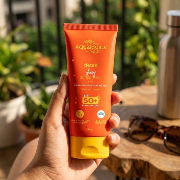 Aqualogica FREEBIE | Detan+ Dewy Sunscreen with SPF 50+ & PA++++ for UVA/B & Blue Light Protection  & No White Cast - 80g held in hand, candid photo