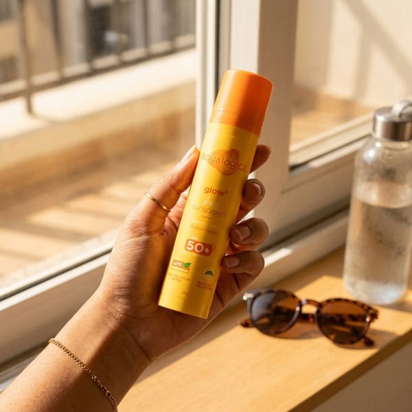 Aqualogica FREEBIE | Glow+ Dewy Sunscreen - 50g held in hand, candid photo
