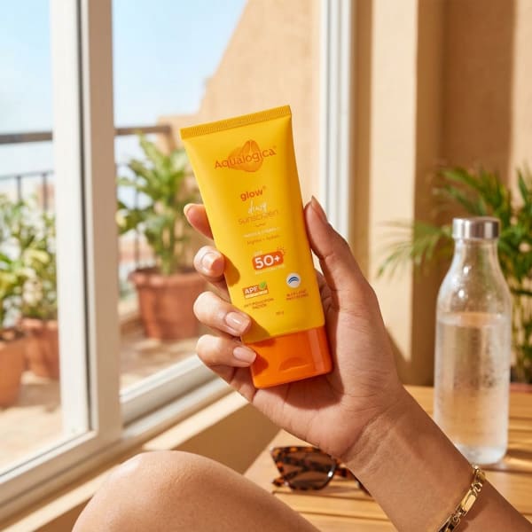 Aqualogica FREEBIE | Glow+ Dewy Sunscreen with SPF 50+ & PA++++ for UVA/B & Blue Light Protection & No White Cast - 80g held in hand, candid photo