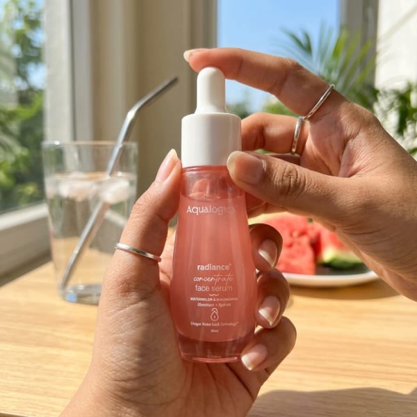 Aqualogica FREEBIE_Radiance+ Concentrate Face Serum - 30 ml held in hand, candid photo