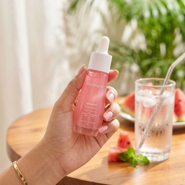 Aqualogica FREEBIE_Radiance+ Concentrate Face Serum - 30 ml held in hand, candid photo