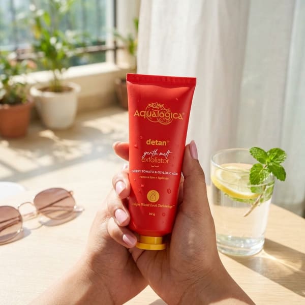 Aqualogica FREEBIE - Detan+ Gentle Melt Exfoliator held in hand, candid photo
