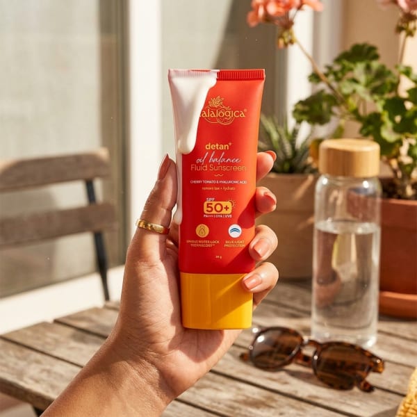 Aqualogica Detan+ Oil Balance Fluid Sunscreen for Oily Skin - 50g held in hand, candid photo