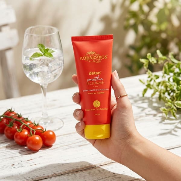 Aqualogica FREEBIE Detan+ Smoothie Face Wash with Cherry Tomato & Glycolic Acid for Tan Removal - 100ml held in hand, candid photo