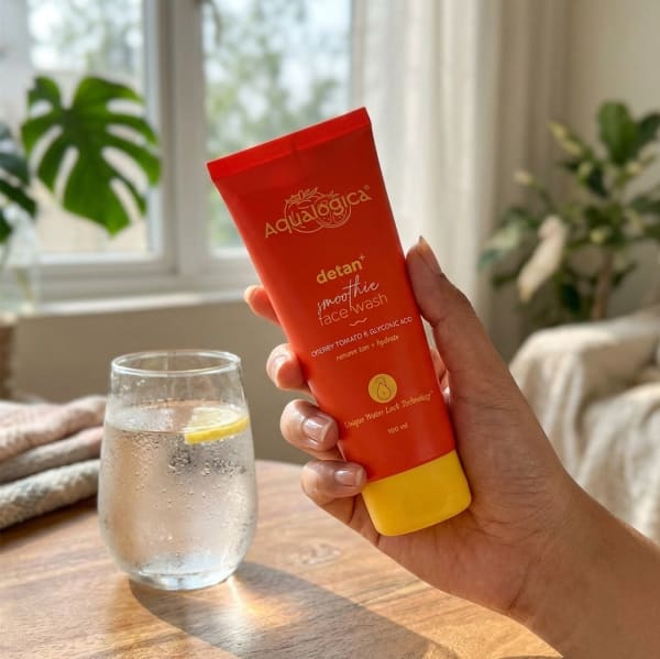 Aqualogica FREEBIE Detan+ Smoothie Face Wash with Cherry Tomato & Glycolic Acid for Tan Removal - 100ml held in hand, candid photo