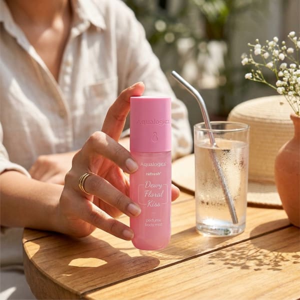 Aqualogica Floral Kiss & Hydration Bliss held in hand, candid photo