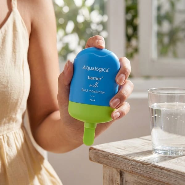Aqualogica FREEBIE - 5 Barrier+ Milk Fluid Moisturizer - 70 ml held in hand, candid photo