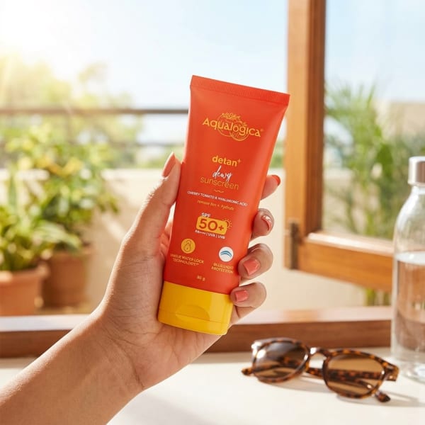 Aqualogica FREEBIE | Detan+ Dewy Sunscreen with SPF 50+ & PA++++ for UVA/B & Blue Light Protection  & No White Cast - 80g held in hand, candid photo