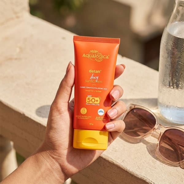 Aqualogica FREEBIE | Detan+ Dewy Sunscreen with SPF 50+ & PA++++ for UVA/B & Blue Light Protection  & No White Cast - 80g held in hand, candid photo