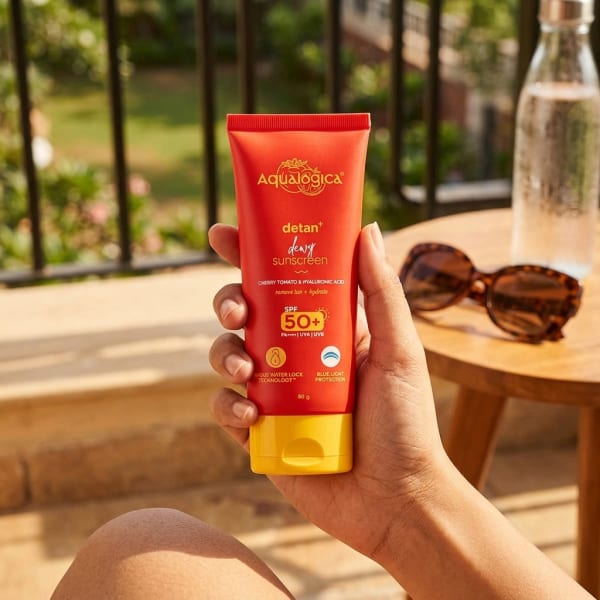 Aqualogica FREEBIE | Detan+ Dewy Sunscreen with SPF 50+ & PA++++ for UVA/B & Blue Light Protection  & No White Cast - 80g held in hand, candid photo