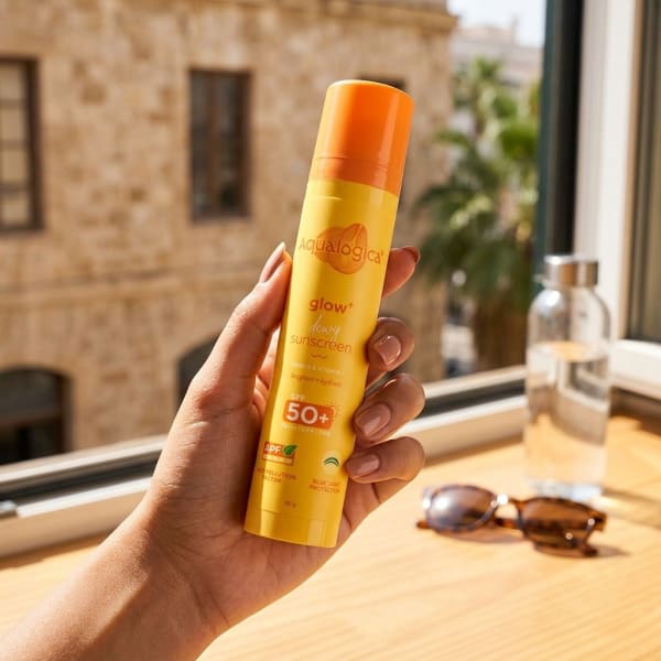 Aqualogica FREEBIE | Glow+ Dewy Sunscreen - 50g held in hand, candid photo