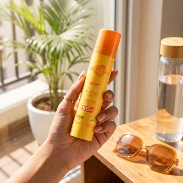 Aqualogica FREEBIE | Glow+ Dewy Sunscreen - 50g held in hand, candid photo