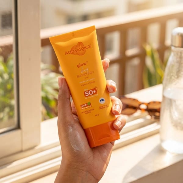 Aqualogica FREEBIE Glow+ Dewy Sunscreen with SPF 50+ & PA++++ for UVA/B & Blue Light Protection & No White Cast - 80g held in hand, candid photo