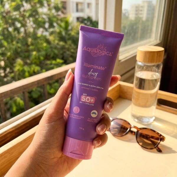 Aqualogica FREEBIE - Illuminate+ Dewy Sunscreen SPF 50+ PA++++ with Wild Berries & Alpha Arbutin - 125 g held in hand, candid photo