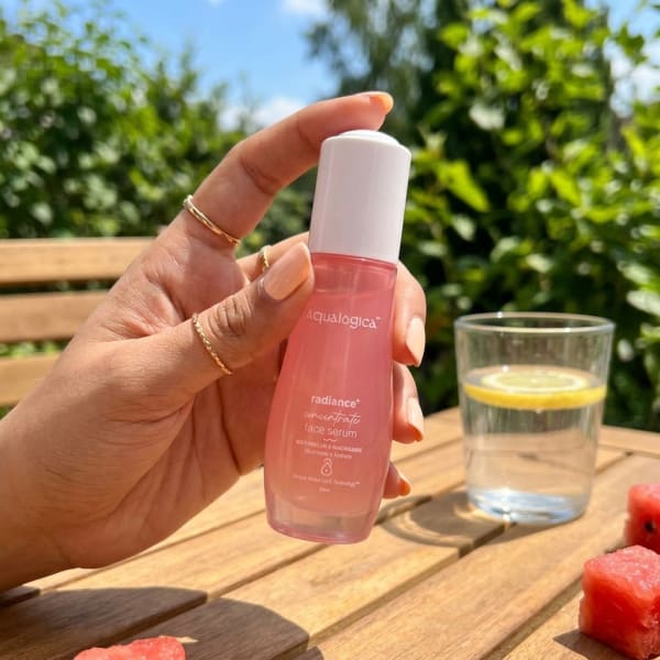 Aqualogica FREEBIE | Radiance+ Concentrate Face Serum 30 ml held in hand, candid photo
